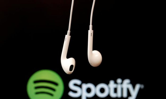 Headphones are seen in front of a logo of online music streaming service Spotify in this Feb. 18, 2014, illustration picture. (Christian Hartmann/File Photo via Reuters)