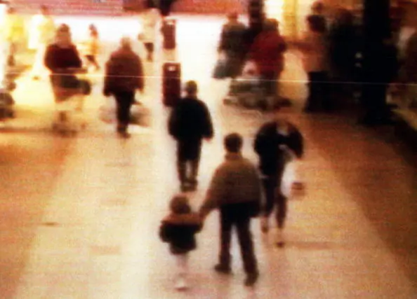 A surveillance camera shows the abduction of two-year-old James Bulger from the Bootle Strand shopping mall Feb. 12 1993 at 3:42pm near Liverpool, England. Bulger holds the hand of Jon Venables, one of two 10-year-old boys later convicted of his torture and murder. (BWP Media via Getty Images)