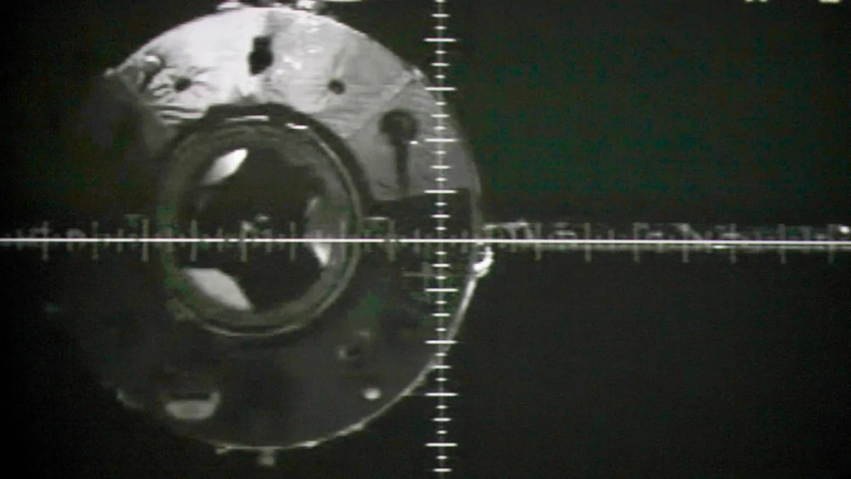 A photo of the giant screen at the Jiuquan space center shows the Tiangong-1 module via a camera in the Shenzhou-9 spacecraft before a docking on July 18, 2012. (STR/AFP/GettyImages)