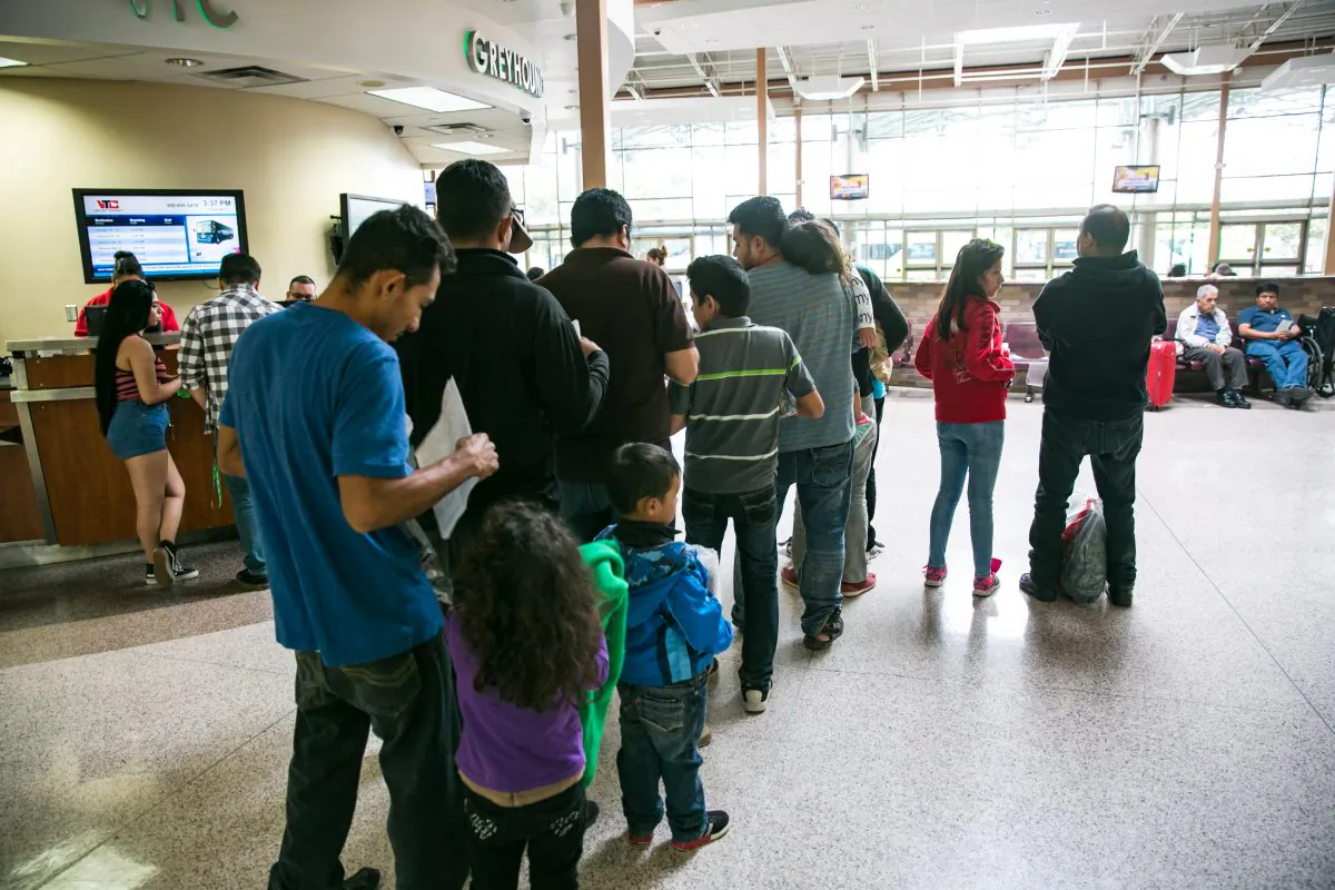 Asylum seekers, mostly from El Salvador, wait in line to purchase bus tickets in McAllen, Texas, on May 30, 2017. (Benjamin Chasteen/The Epoch Times)