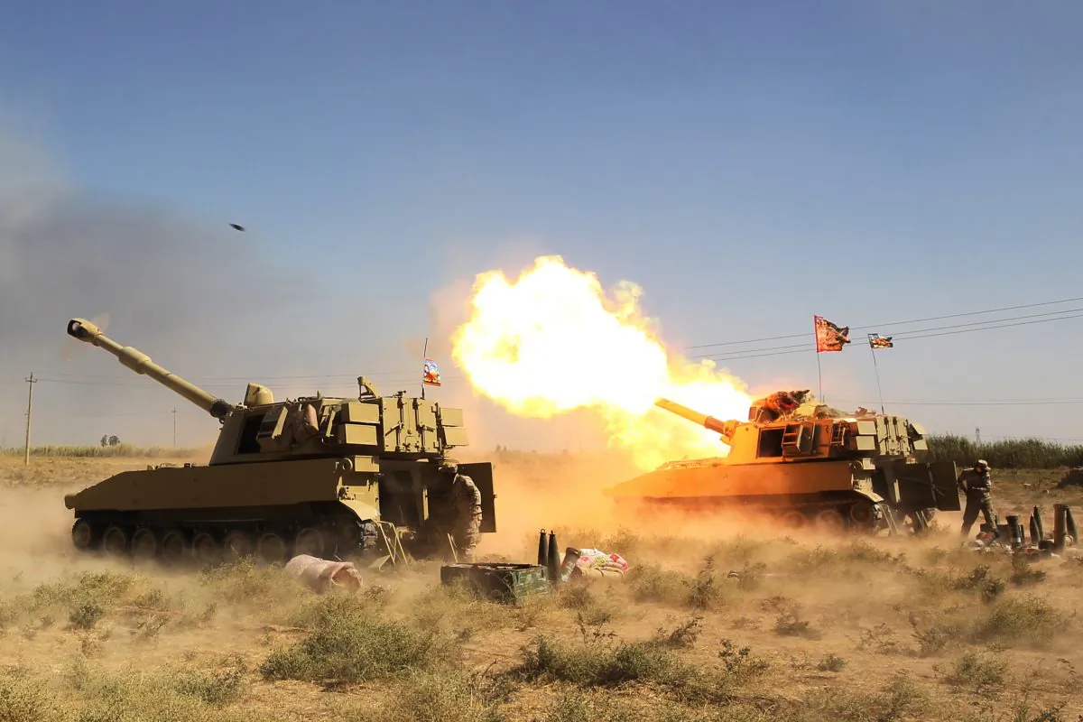 Iraqi forces, backed by the Hashed al-Shaabi (Popular Mobilisation units), fire artillery from a position near the ISIS group's stronghold of Hawija, during an operation to recapture the town from the jihadists on Oct. 4, 2017. (Ahmad Al-Rubaye/AFP/Getty Images)