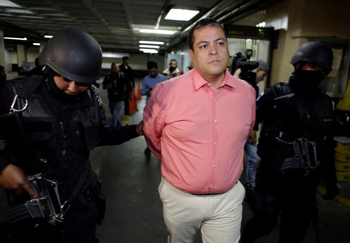 Congressman Julio Juarez Ramirez, who is accused of plotting the murders of two journalists in 2015, is escorted by police officers while arriving to the court in Guatemala City, Guatemala, Jan. 13, 2018. (Reuters/Luis Echeverria)