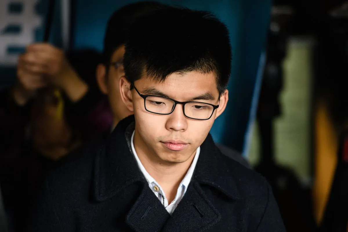 Pro-democracy activist Joshua Wong prepares to enter the High Court to hear his sentence on a protest related charge in Hong Kong on Jan. 17, 2018.  (ANTHONY WALLACE/AFP/Getty Images)