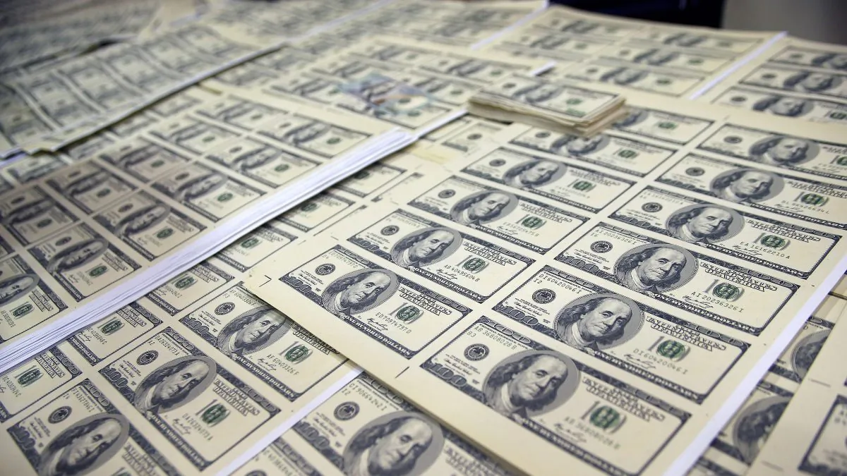 Sheets of counterfeit US dollar bills are displayed after a gang dedicated to forgery was dismantled in Lima, Peru on May 10, 2014. (AFP/Getty Images)