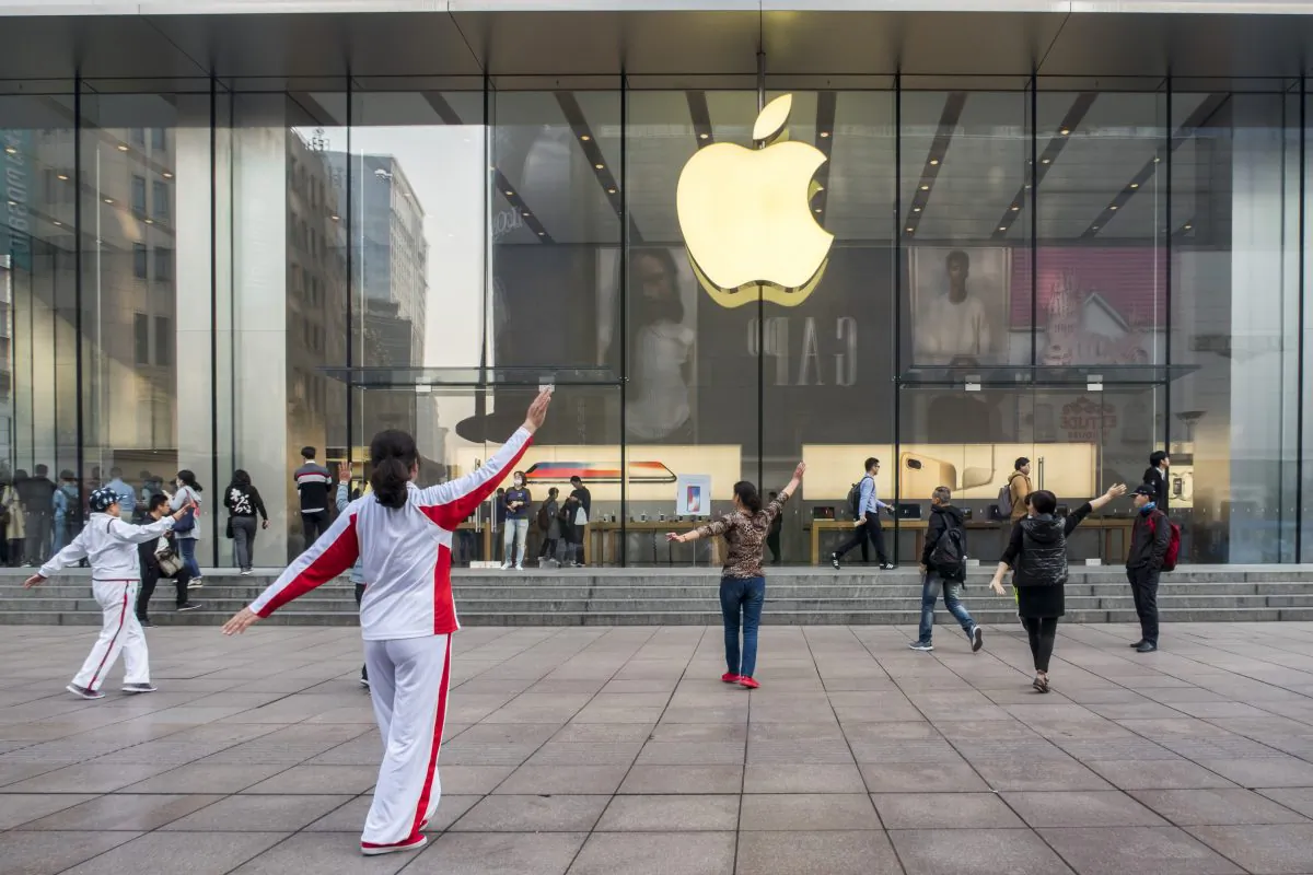 Elderly people perform square dance in front of an Apple store in Shanghai on Nov. 3, 2017. Apple is relinquishing control over its iCloud servers for Chinese users to a Chinese state-owned company in China, citing compliance with Chinese laws. (VCG via Getty Images)