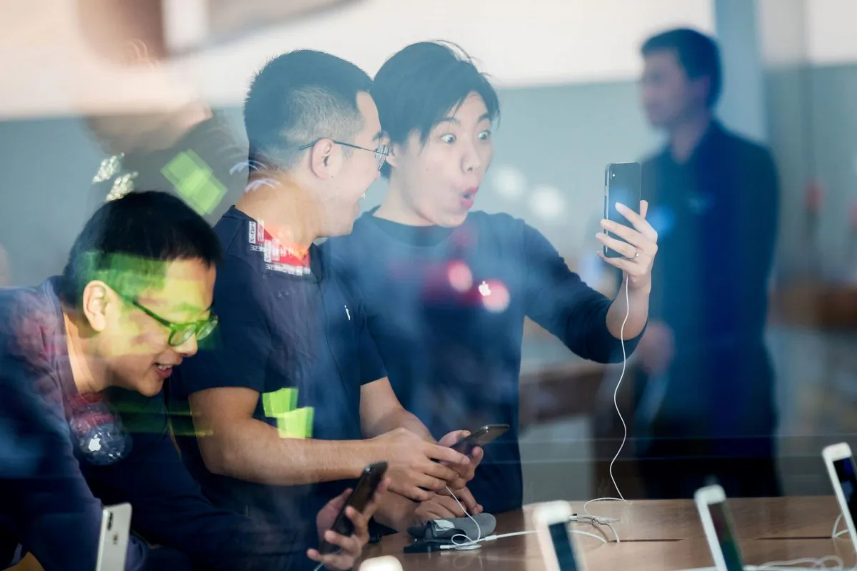 Chinese customers look at the new iPhone X at the Apple store in Hangzhou in China's eastern Zhejiang province on November 3, 2017. (STR/AFP/Getty Images)