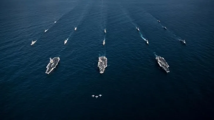 Three F/A-18E Super Hornets fly in formation over the aircraft carriers USS Ronald Reagan (CVN 76), USS Theodore Roosevelt (CVN 71), USS Nimitz (CVN 68) and their strike groups along with ships from the Republic of Korea Navy as they transit the Western Pacific on Nov. 12, 2017. (Aaron B. Hicks/U.S. Navy/Handout via Reuters)