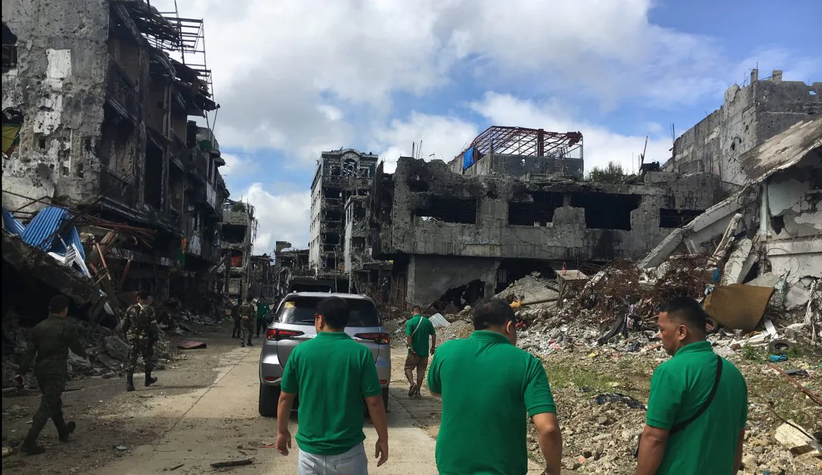 Community leaders survey damaged houses and buildings inside war-torn Marawi, Philippines Jan. 13, 2018. (Reuters/Tom Allard)