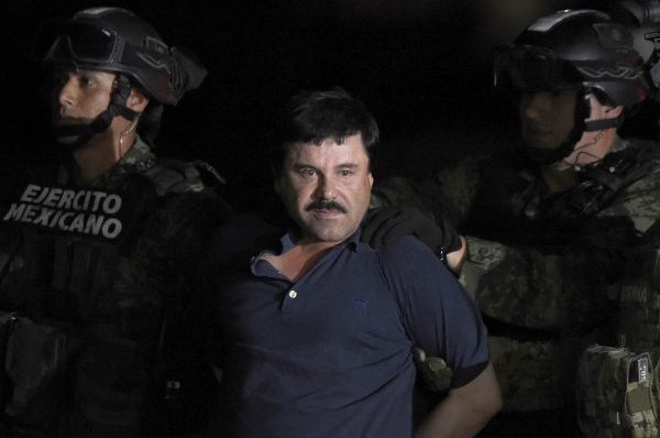 Drug kingpin Joaquin "El Chapo" Guzman is escorted into a helicopter