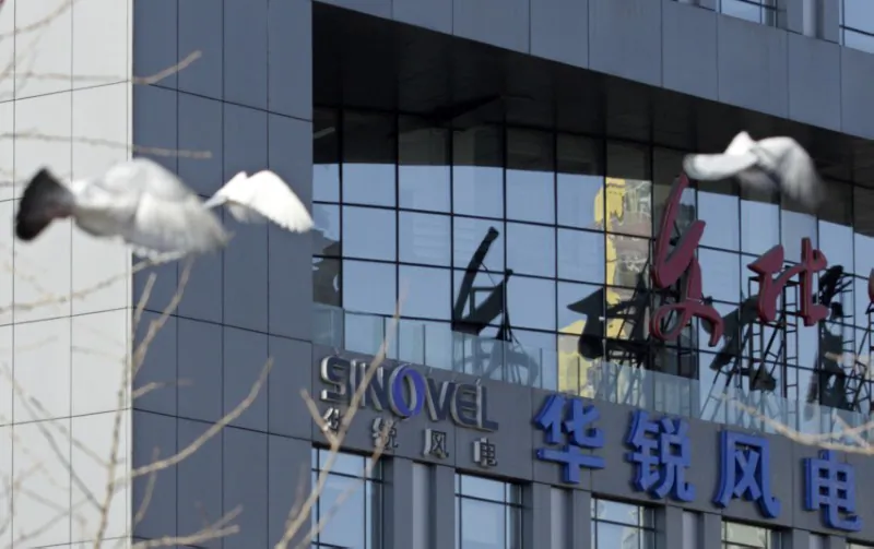 Pigeons fly past the company logo of Sinovel Wind Co., Ltd. outside its head office in Beijing, on Jan. 6, 2011. (Soo Hoo Zheyang/REUTERS)