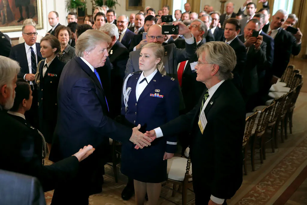 President Donald Trump shakes hands with Mayor Timothy McDonough of Hope Township, New Jersey, while hosting mayors for a speech in the East Room of the White House, in Washington on Jan. 24, 2018. (Chip Somodevilla/Getty Images)
