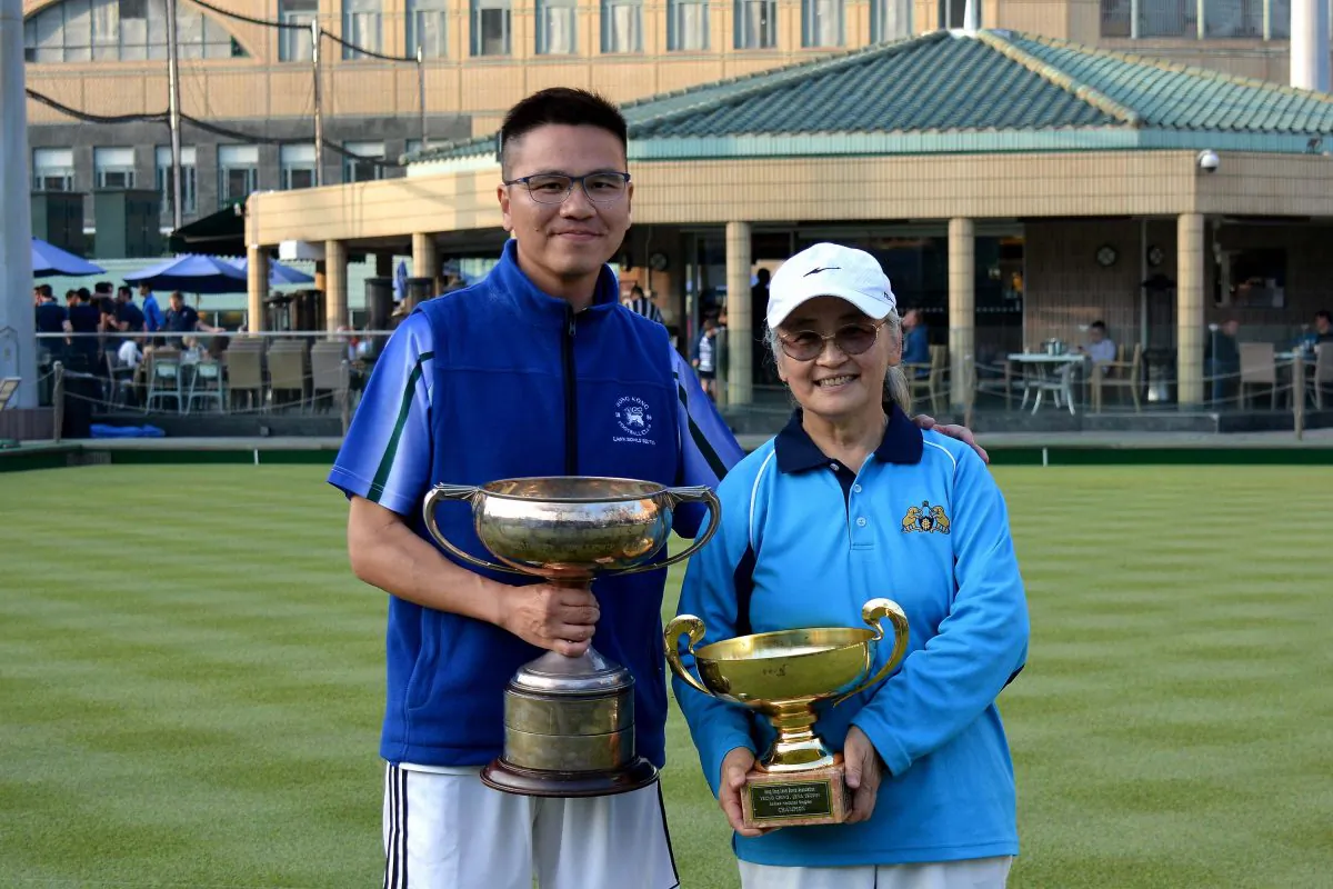 Tony Cheung from Hong Kong Football Club (left) and Shirley Ko of Indian Recreation Club proudly display their National Singles trophy after winning their respective finals on Sunday Jan 21. (Stephanie Worth)