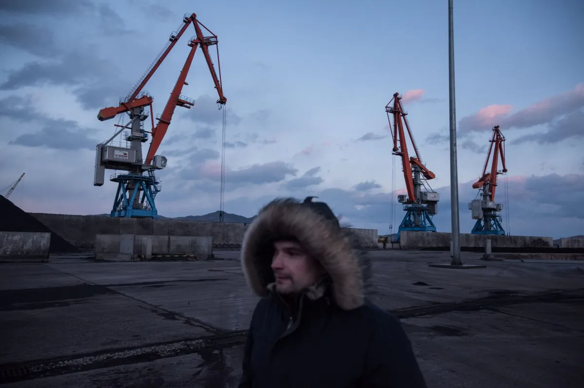 A Russian worker walking past cranes at the RasonConTrans coal port at Rajin harbour in the Rason Special Economic Zone on Nov. 21, 2017 . (Ed Jones/AFP/Getty Images)