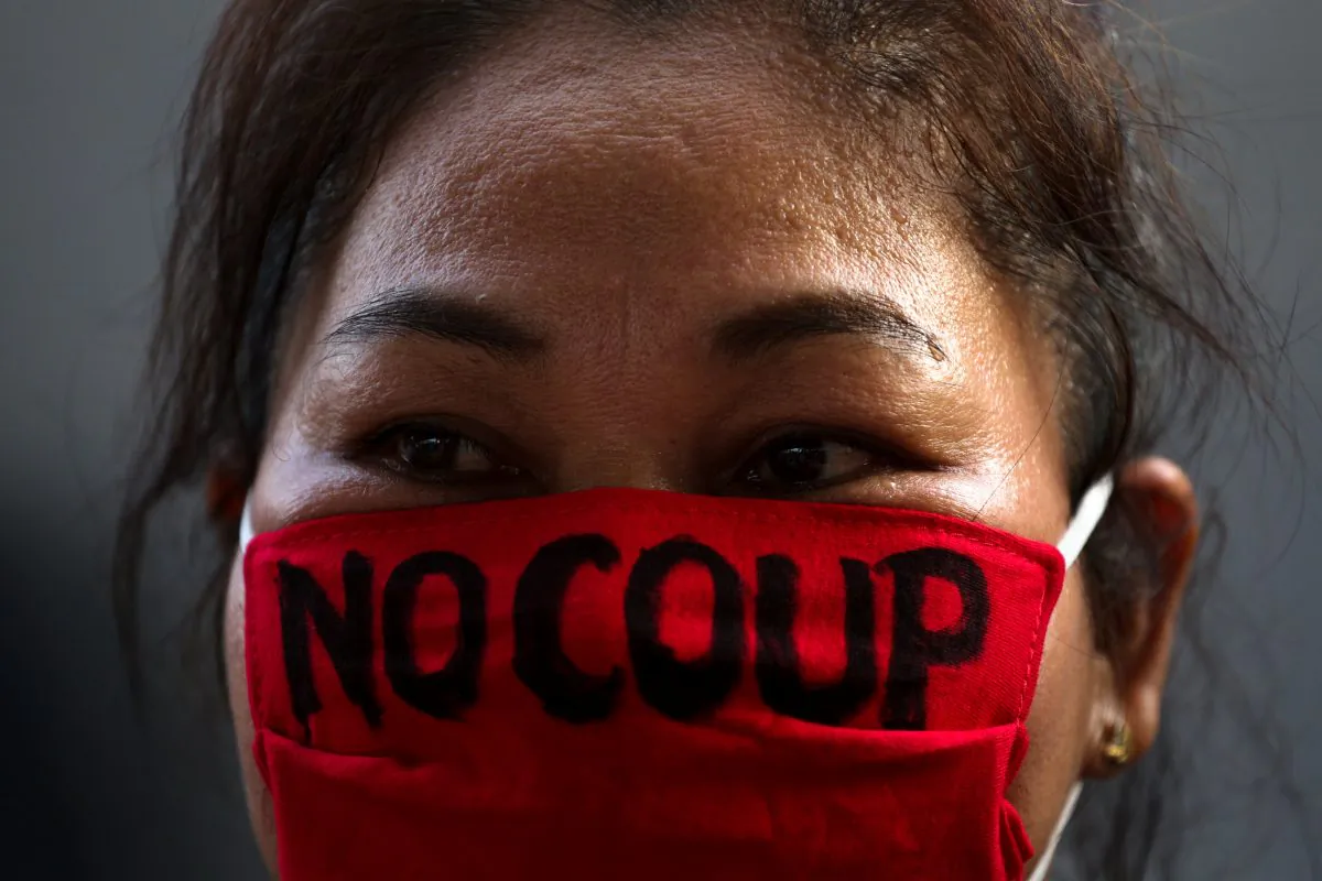 A pro-democracy protester wearing the face mask with a written message, takes part in a protest against junta delaying polls in Bangkok, Thailand Jan. 27, 2018. (Reuters/Athit Perawongmetha)