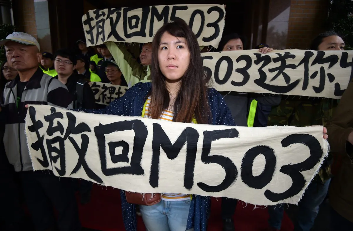 Taiwanese activists display banners that read “oppose the M503” at the Parliament during a protest in Taipei on March 27, 2015. China is now activating the controversial M503 air route that was first declared in 2015. (Same Yeh/AFP/Getty Images)