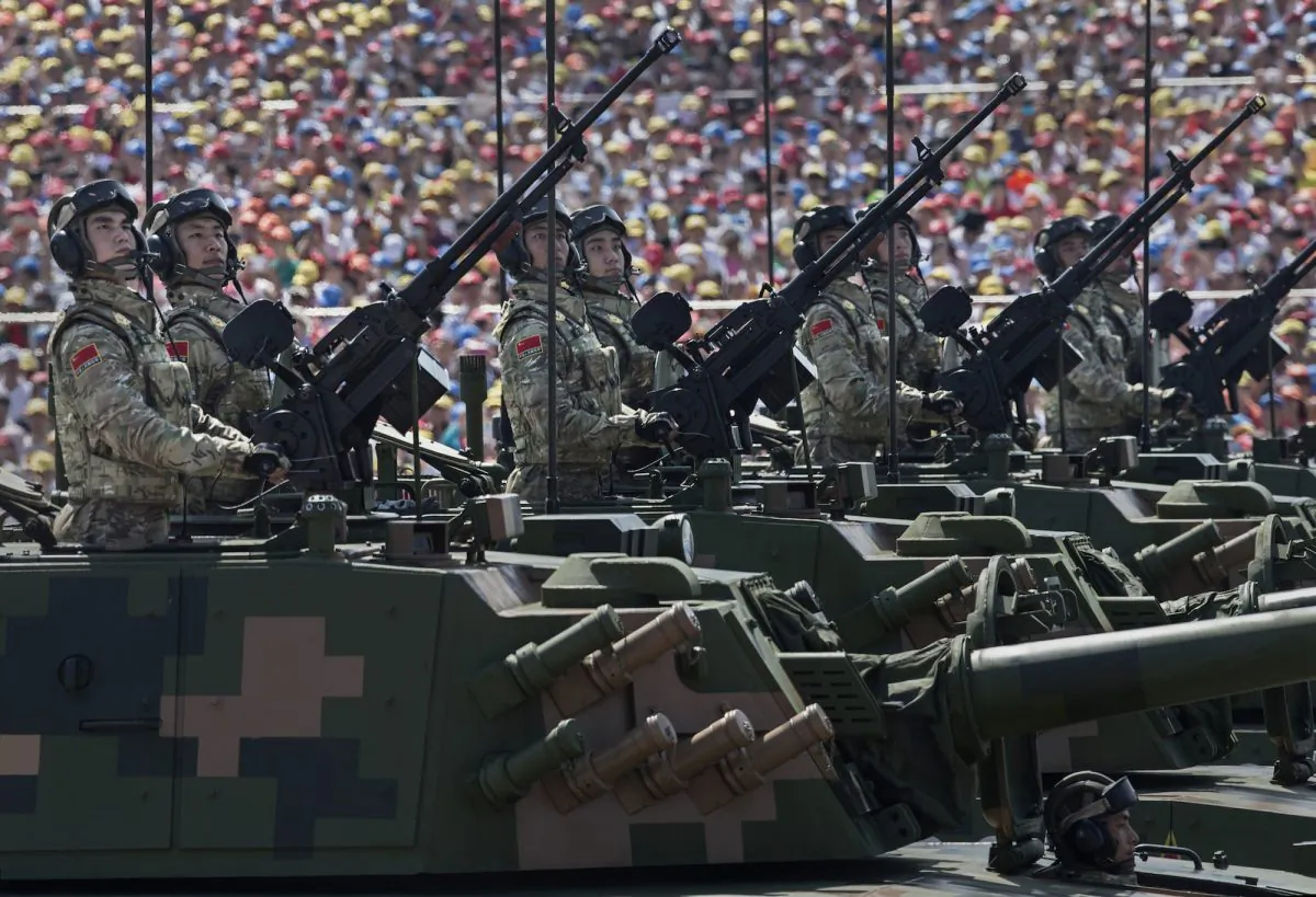 Chinese soldiers ride in tanks as they pass in front of Tiananmen Square and the Forbidden City during a military parade in Beijing on Sept. 3, 2015. (Kevin Frayer/Getty Images)