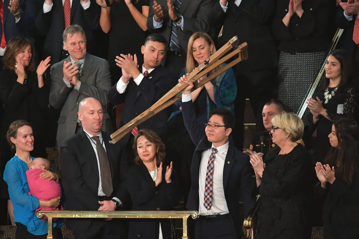 North Korean defector Ji Seong-ho raises his crutches as he is recognized by President Donald Trump during the State of the Union address at the US Capitol in Washington, DC, on Jan. 30, 2018. (MANDEL NGAN/AFP/Getty Images)