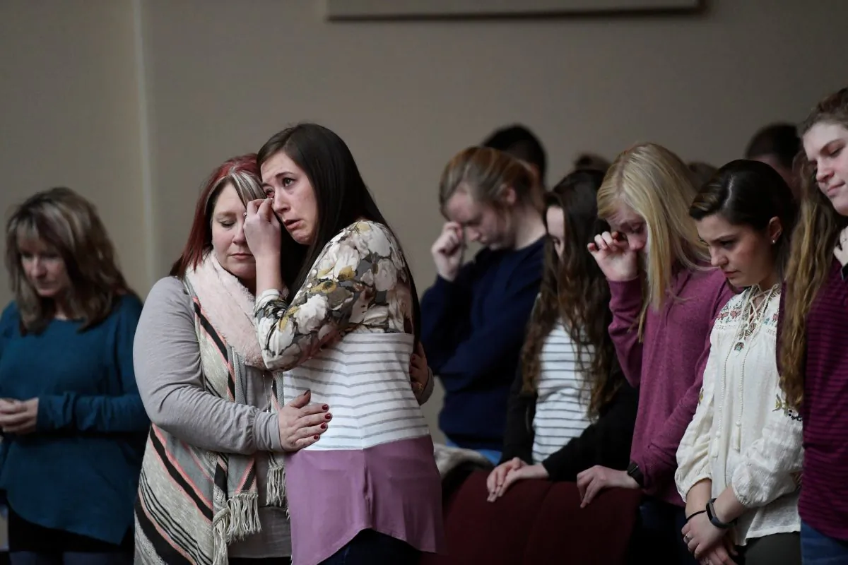 Students attend a prayer vigil for students killed and injured after a 15-year-old boy opened fire with a handgun at Marshall County High School, at Life in Christ Church in Marion, Kentucky on Jan. 23, 2018. (REUTERS/Harrison McClary)