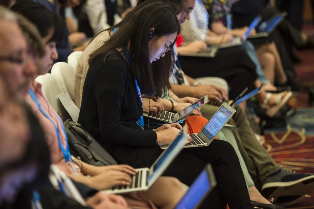 Chinese journalists work on their computers during the G20 meeting in Chengdu, in western China's Sichuan Province on July 23, 2016. Observers say that the digitalization of journalism and the emergence of social media have done little to increase press freedom in China, as Chinese regime rapidly moved to impose censorship on new platforms. (Fred Dufour/AFP/Getty Images)