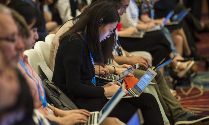 Chinese journalists work on their computers during the G20 meeting in Chengdu, in western China's Sichuan Province on July 23, 2016. Observers say that the digitalization of journalism and the emergence of social media have done little to increase press freedom in China, as Chinese regime rapidly moved to impose censorship on new platforms. (Fred Dufour/AFP/Getty Images)