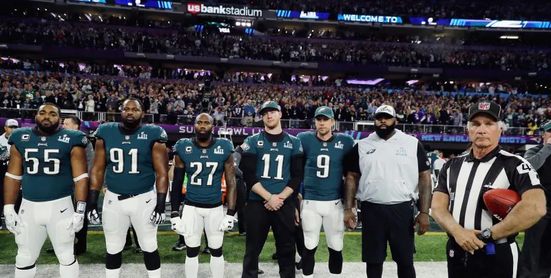 Brandon Graham #55, Fletcher Cox #91, Malcolm Jenkins #27, Carson Wentz #11 and Nick Foles #9 of the Philadelphia Eagles stand for the national anthem prior to Super Bowl LII against the New England Patriots at U.S. Bank Stadium on Feb. 4, 2018 in Minneapolis, Minnesota.  (Photo by Elsa/Getty Images)