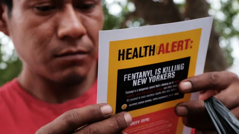 A heroin user reads an alert on fentanyl before being interviewed by John Jay College of Criminal Justice students as part of a project to interview Bronx drug users in order to compile data about overdoses on August 8, 2017 in New York City. (Spencer Platt/Getty Images)