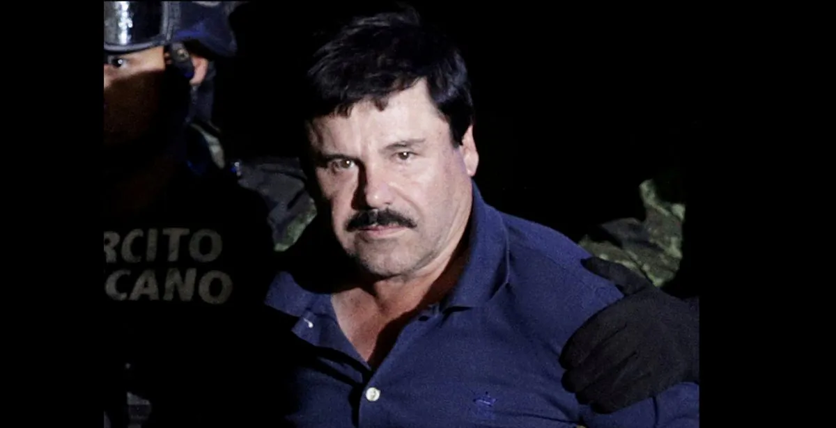 Recaptured drug lord Joaquin "El Chapo" Guzman is escorted by soldiers at the hangar belonging to the office of the Attorney General in Mexico City, Mexico, on Jan 8, 2016. (Henry Romero/Reuters)