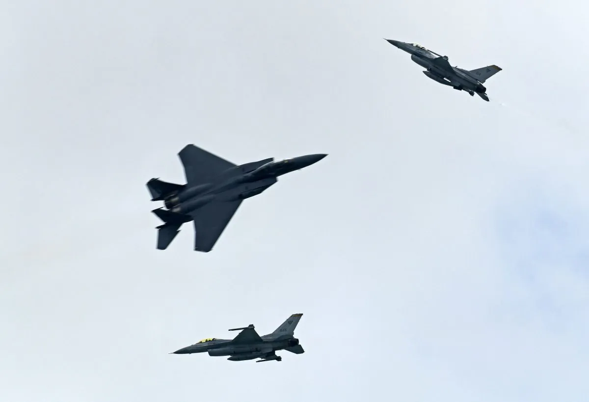 A Singapore Air Force aerobatic team comprising of two F-16Cs and an F-15SG fighter aircraft performs an aerial display during a media preview for the Singapore Airshow in Singapore on February 4, 2018. (Roslan Rahman/AFP/Getty Images)