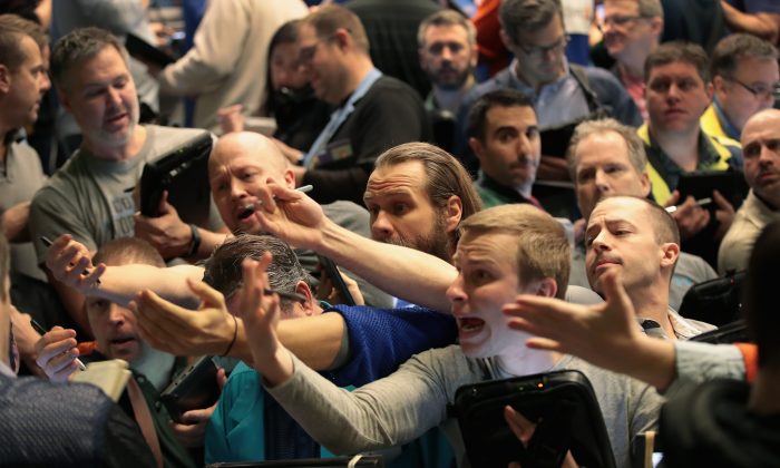 Traders signal offers in the S&P options pit at the Cboe Global Markets Inc. exchange in Chicago on Feb. 6.  (Scott Olson/Getty Images)