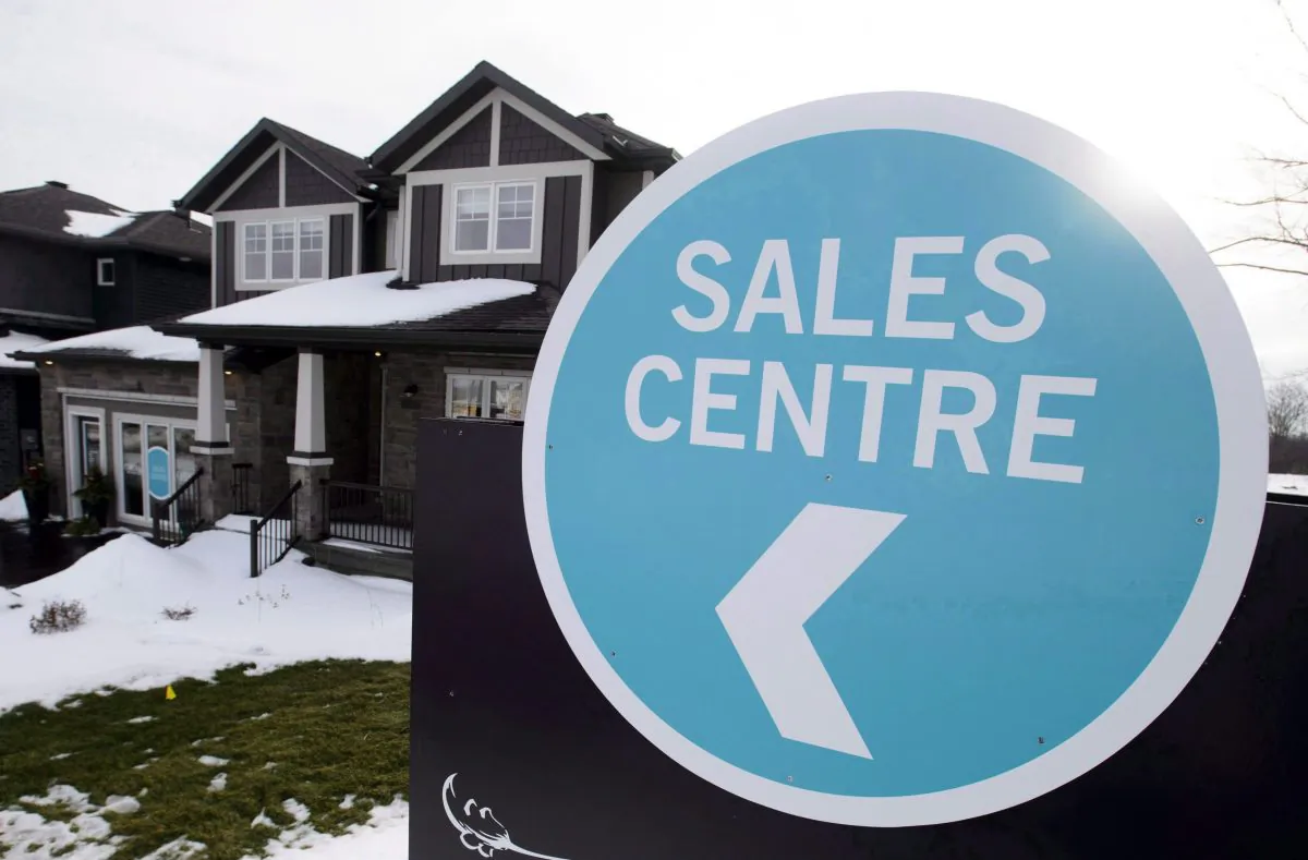 A sales center sign is shown outside a house under construction in Beckwith, Ont., on Jan. 11, 2018. The mortgage business faces challenges from rising rates and the newly implemented stress test from the federal regulator. (The Canadian Press/Sean Kilpatrick)