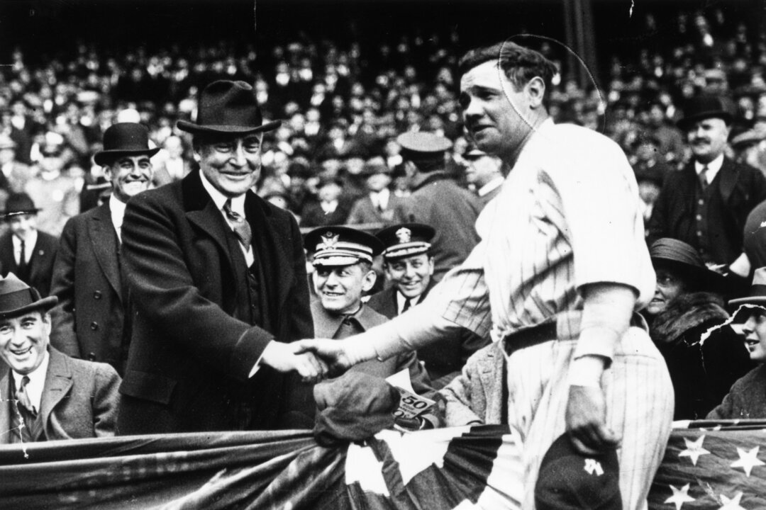 Great all-round baseball player, Babe Ruth (George Herman Ruth, 1895 - 1948) shakes hands with the 29th President of the USA, Warren Harding. After the handshake Babe Ruth hit a home run to help his team, the New York Yankees win the third game of the series with the Wash. (Keystone/Getty Images)