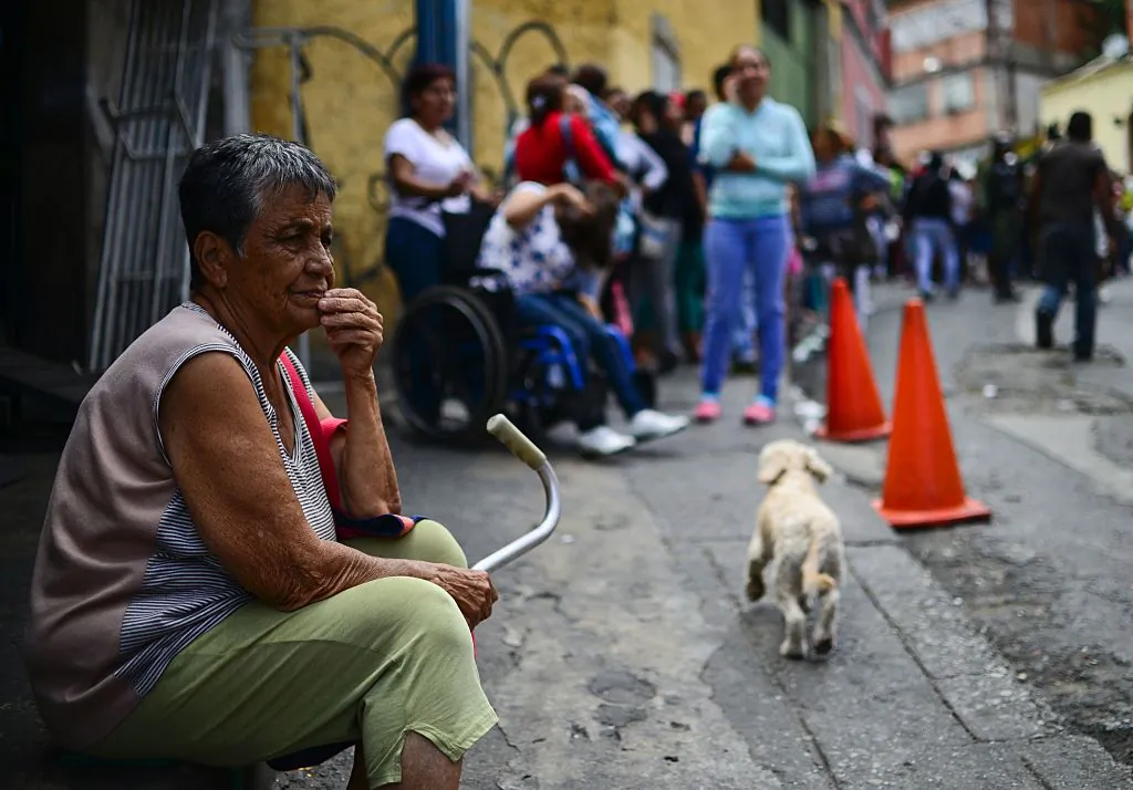 An elderly woman lines up to buy basic food and household items outside a supermarket in the poor neighborhood of Lidice, in Caracas, Venezuela on May 27, 2016. (RONALDO SCHEMIDT/AFP/Getty Images)