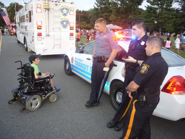 Police officers from various agencies listening to a boy attending the Livingston Police Department National Night Out, Aug. 7, 2013. (Vincent J. Bove)
