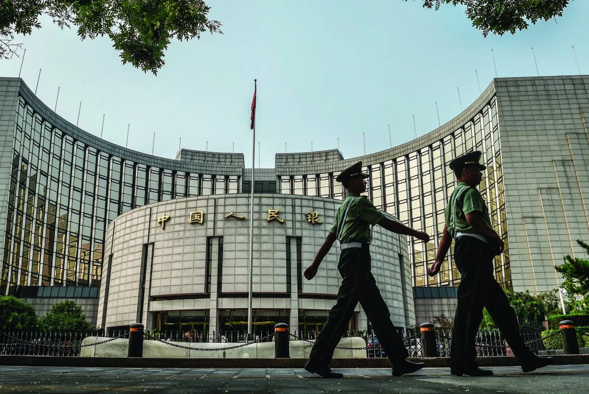 Paramilitary policemen patrol in front of the People’s Bank of China, the central bank of China, in Beijing on July 8, 2015. (Greg Baker/AFP/Getty Images)