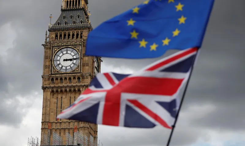 The Union Flag and a European Union flag fly in Parliament Square, in central London, on Sept. 9, 2017. (Tolga Akmen/Reuters)
