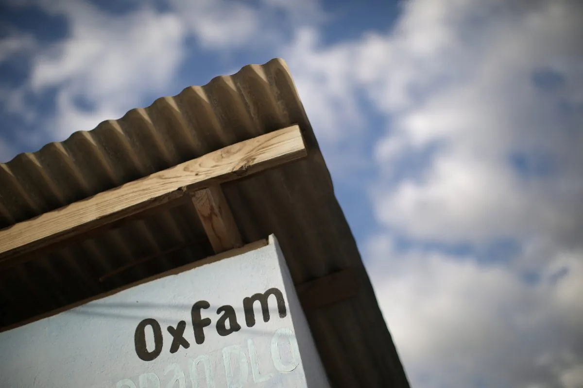 An Oxfam sign is seen on a kiosk that was used to distribute water in Corail, a camp for displaced people of the 2010 earthquake, on the outskirts of Port-au-Prince, Haiti, Feb. 13, 2018. (Reuters/Andres Martinez Casares)