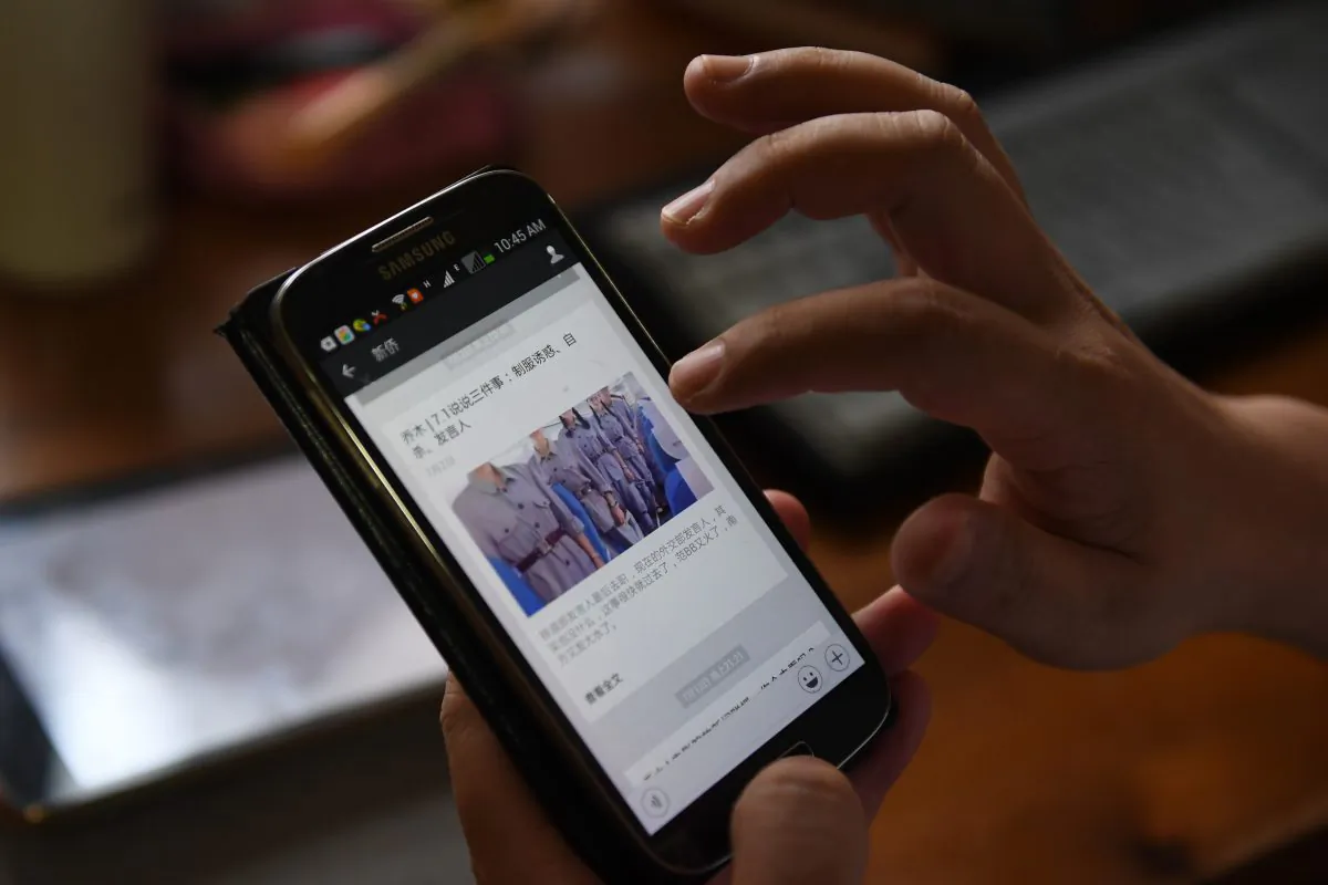 A social media post appearing on a mobile phone in Beijing, on July 21, 2017. (Greg Baker/AFP/Getty Images)