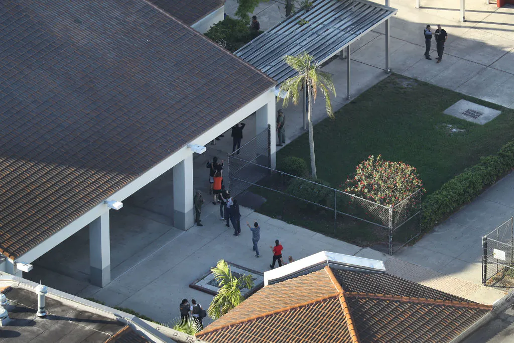 People are brought out of the Marjory Stoneman Douglas High School after a shooting at the school that reportedly killed and injured multiple people in Parkland, Florida, on Feb. 14, 2018. (Joe Raedle/Getty Images)
