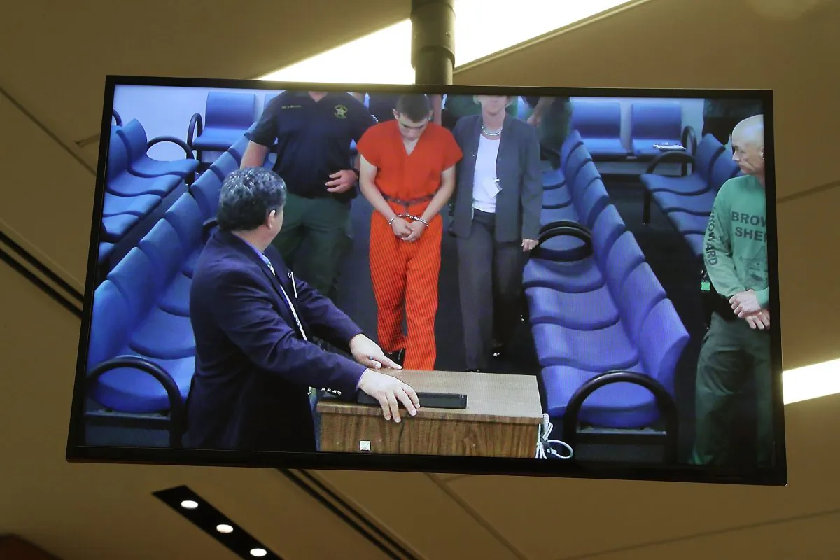 Nikolas Cruz, 19, a former student at Marjory Stoneman Douglas High School in Parkland, Florida, where he allegedly killed 17 people, is seen on a closed circuit television screen during a bond hearing in front of Broward Judge Kim Mollica at the Broward County Courthouse in Fort Lauderdale, Florida on Feb. 15, 2018. Mr. Cruz is possibly facing 17 counts of premeditated murder in the school shooting. (Photo by Susan Stocker - Pool/Getty Images)