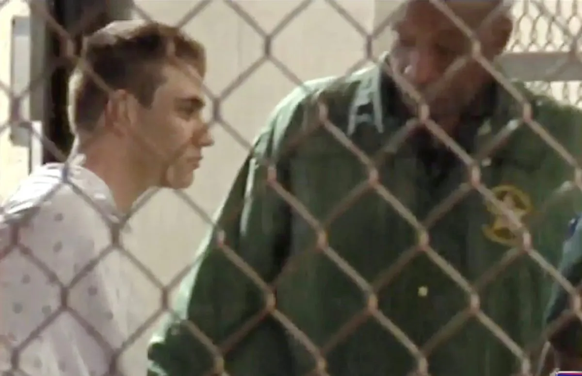Police escort Nikolas Cruz into Broward County Jail on Feb. 15, 2018 in a still image from video following a shooting incident at Marjory Stoneman Douglas High School, in Fort Lauderdale, Florida, U.S.
 (WSVN.com via Reuters)