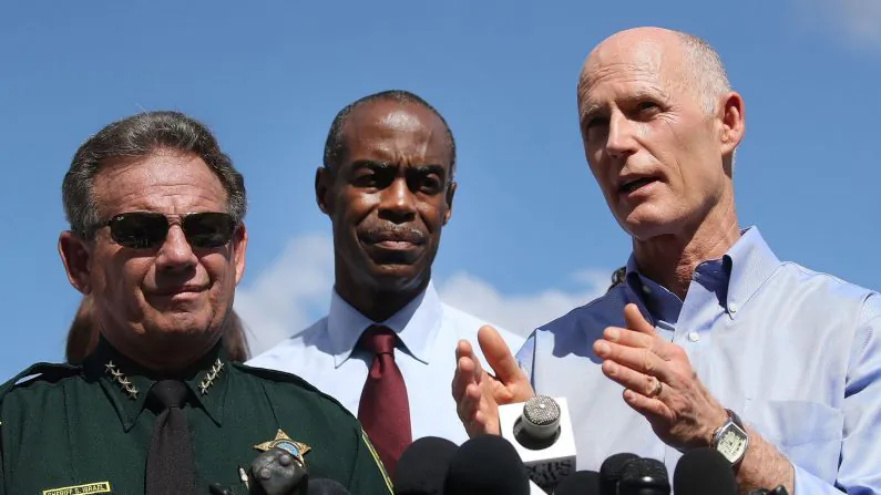 Florida Governor Rick Scott (R), Broward County Superintendent of Schools, Robert W. Runcie (C) and Broward County Sheriff, Scott Israel (L) speak to the media about the mass shooting at Marjory Stoneman Douglas High School where 17 people were killed yesterday in Parkland, Florida on Feb. 15, 2018. (Mark Wilson/Getty Images)