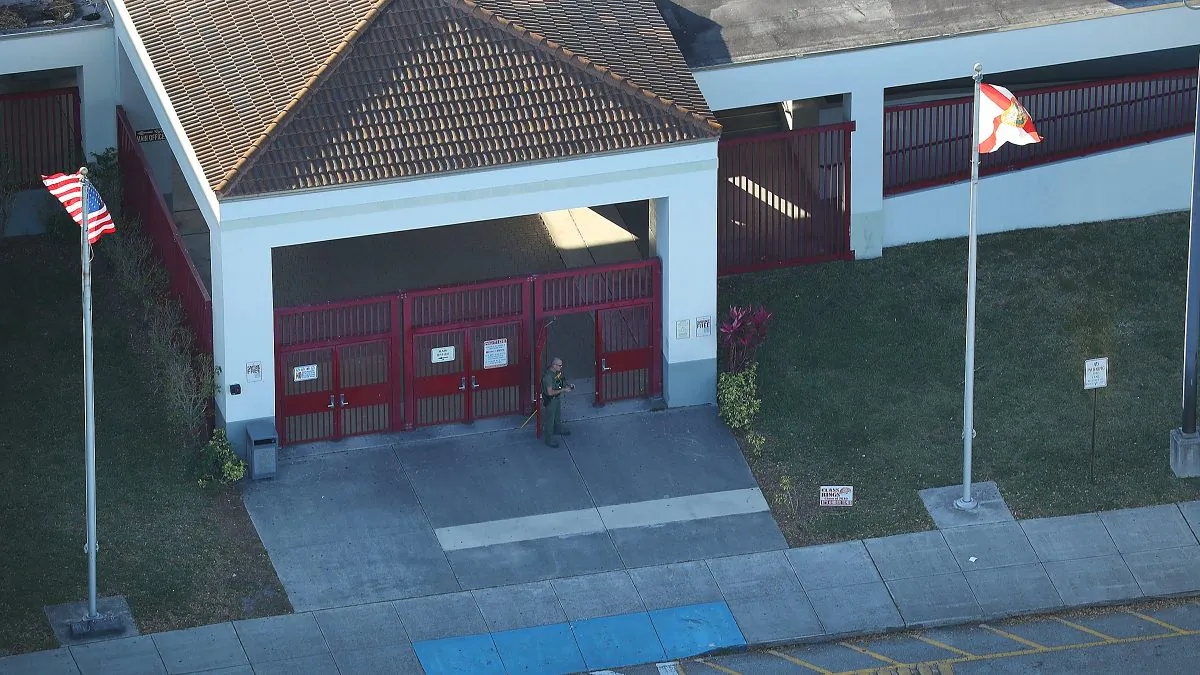 A law enforcement officer stands at the front door of the Marjory Stoneman Douglas High School after a shooting at the school that reportedly killed and injured multiple people on February 14, 2018 in Parkland, Florida. (Joe Raedle/Getty Images)