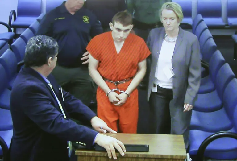 Nikolas Cruz, who has confessed to a deadly shooting spree at his his former high school, is seen in this February 15, 2018 file photo, accompanied by his lawyers POOL/AFP/File / Susan STOCKER-SUN SENTINEL
