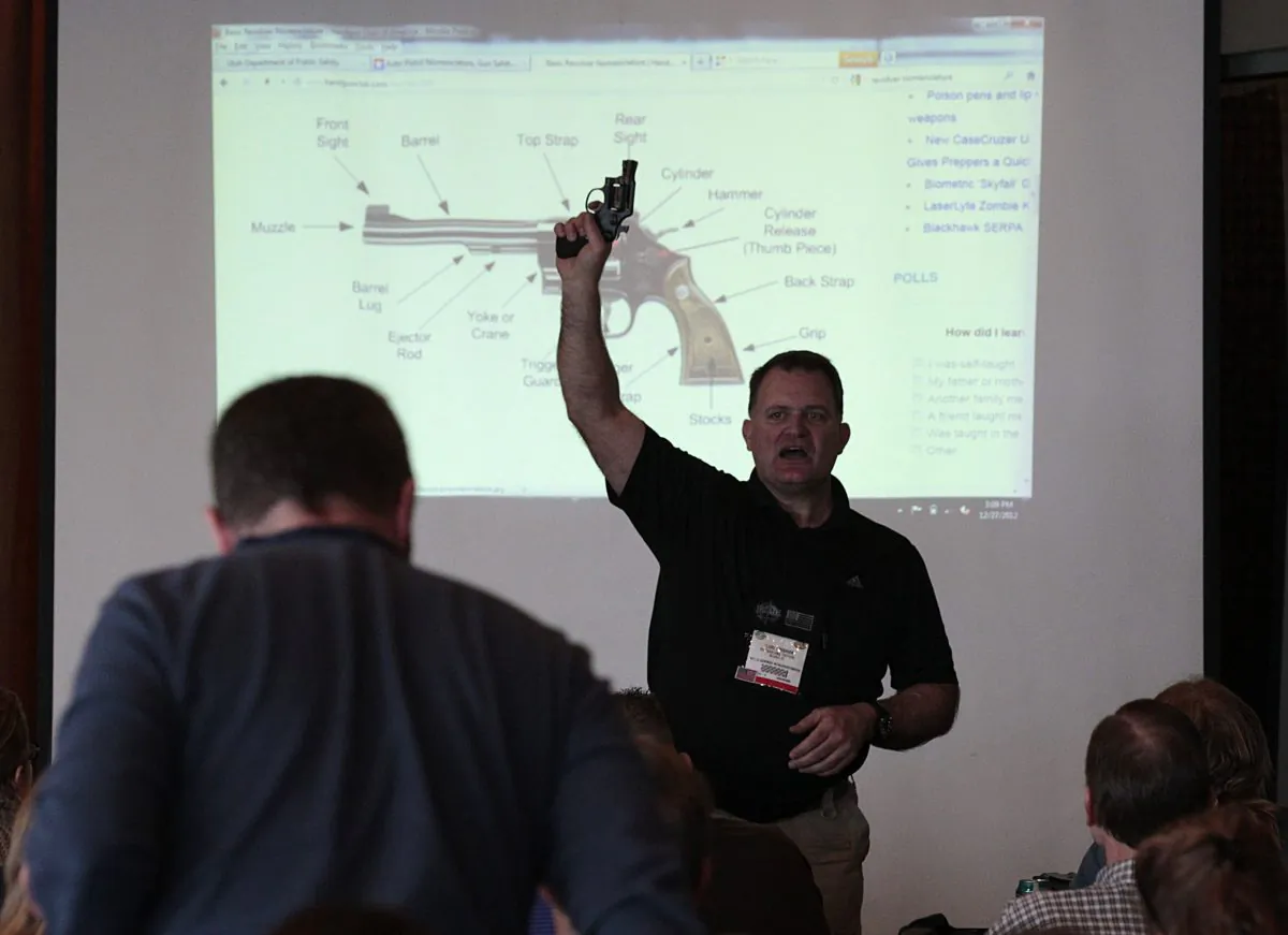 Firearm instructor Clark Aposhian teaches a concealed-weapons training class to 200 Utah teachers in West Valley City, Utah on Dec. 27, 2012. (Photo by George Frey/Getty Images)