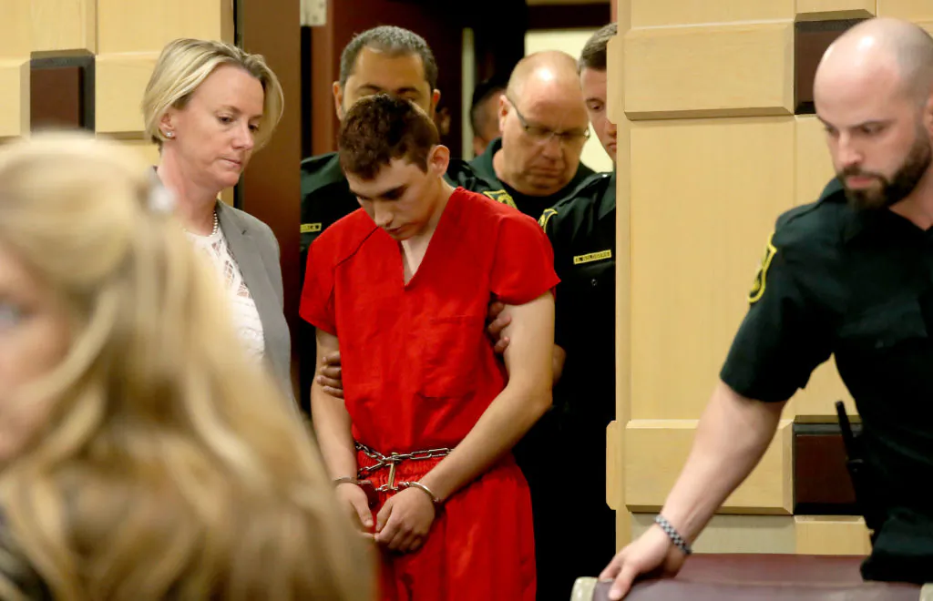 Nikolas Cruz appears in court with attorney Melissa McNeil (L) for a status hearing before Broward Circuit Judge Elizabeth Scherer on Feb. 19, 2018 in Ft. Lauderdale, Florida. (Mike Stocker-Pool/Getty Images)