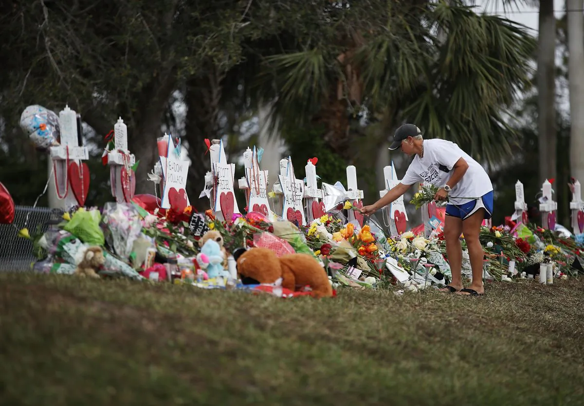 Melissa Shev visits a makeshift memorial setup in front of Marjory Stoneman Douglas High School in memory of the 17 people that were killed on Feb. 14, in Parkland, Florida on Feb. 20, 2018. (Joe Raedle/Getty Images)