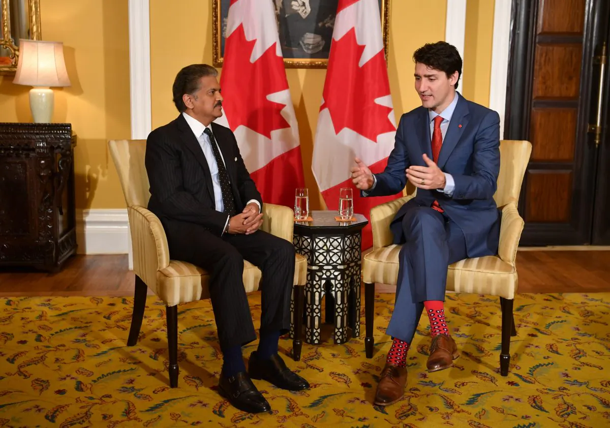 Canada's Prime Minister Justin Trudeau chats with the chairman of Indian multinational conglomerate Mahindra Group, Anand Mahindra, in Mumbai, India, on Feb. 20, 2018. Canada and India are seeking to forge stronger business ties. (Indranil Mukherjee/AFP/Getty Images)
