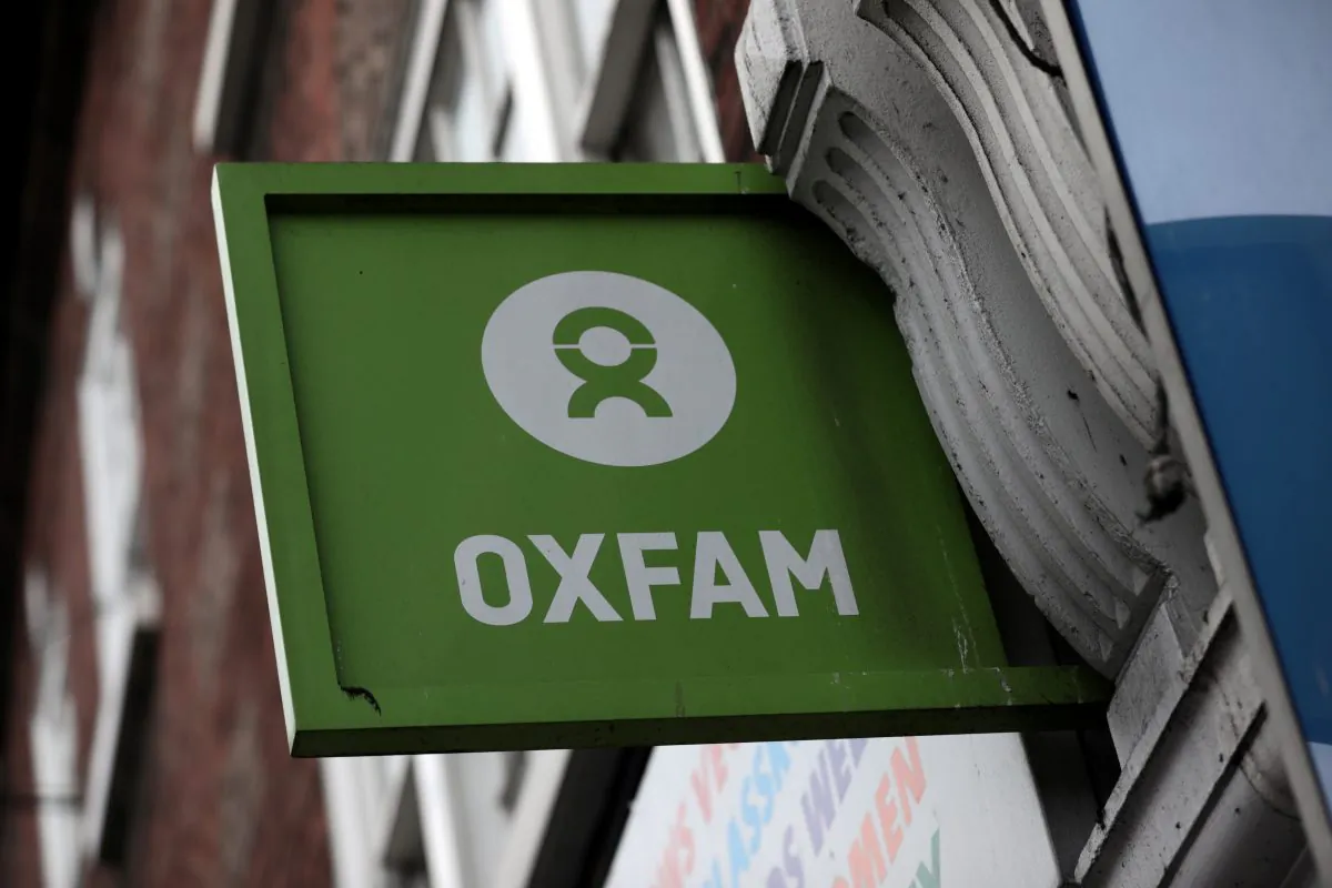 A sign is seen above a branch of Oxfam, in central London, Britain February 13, 2018. (Reuters/Simon Dawson)