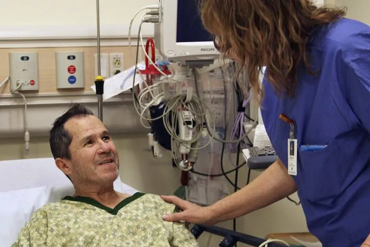Crispin Lopez Serrano talks to an oncology nurse at a hospital in Clackamas, Ore., on Dec. 3, 2014. (AP Photo/Gosia Wozniacka)