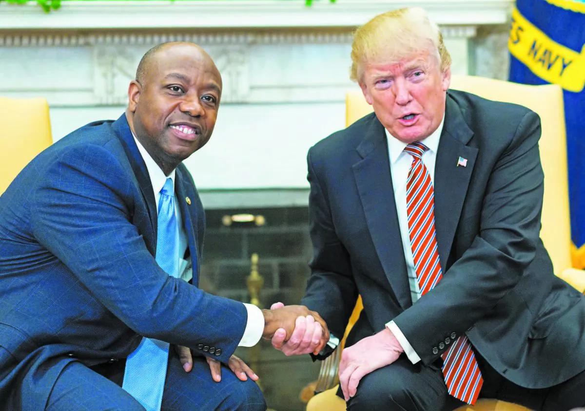 Sen. Tim Scott (R-S.C.) and President Donald Trump shake hands during a working session regarding Opportunity Zones following the recently signed tax bill at the White House on Feb. 14. (MANDEL NGAN/AFP/GETTY IMAGES
KCNA VIA)